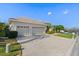 Three-car garage with a wide driveway, enhancing curb appeal and functionality at 6683 Highlands Creek Blvd, Lakeland, FL 33813