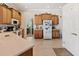 Bright kitchen with wood cabinets, light countertops, and modern appliances at 6683 Highlands Creek Blvd, Lakeland, FL 33813