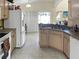 Kitchen with light wood cabinets and white appliances at 1333 Rebecca Dr, Haines City, FL 33844