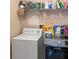 Laundry room with washer, dryer, and shelving at 1333 Rebecca Dr, Haines City, FL 33844