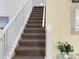 Carpeted staircase with white railing at 1333 Rebecca Dr, Haines City, FL 33844