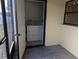 Enclosed laundry room with washer and dryer hookups, and tile flooring, conveniently located at 16 Kendra Ct # 16, Winter Haven, FL 33880