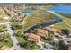 Scenic aerial view showcasing beautiful homes with tile roofs, lush landscaping, water features, and golf course views at 4101 Limerick Dr, Lake Wales, FL 33859