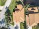Aerial view of a well-maintained home with a brown shingle roof, lush landscaping, and a brick driveway at 4101 Limerick Dr, Lake Wales, FL 33859