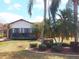 Backyard features lush green landscaping and a cozy screened-in lanai at 4101 Limerick Dr, Lake Wales, FL 33859