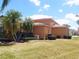 Expansive backyard with palm trees and well-maintained landscaping and view of enclosed lanai at 4101 Limerick Dr, Lake Wales, FL 33859