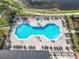 Aerial view of the community pool with brick pavers, lounge chairs, manicured landscaping, and beautiful design at 4101 Limerick Dr, Lake Wales, FL 33859