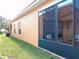 Side view of home featuring an enclosed lanai with several windows at 4101 Limerick Dr, Lake Wales, FL 33859