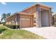 Beautifully landscaped house featuring a wide paved driveway and a two-car garage at 4101 Limerick Dr, Lake Wales, FL 33859