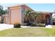 Charming single-story home featuring a stone-accented facade, well-manicured lawn, and mature palm trees at 4101 Limerick Dr, Lake Wales, FL 33859