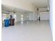 Spacious three-car garage with clean epoxy flooring and ample storage, including a utility sink at 4101 Limerick Dr, Lake Wales, FL 33859