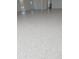 Close-up view of epoxy flooring in the garage with light gray and white specks at 4101 Limerick Dr, Lake Wales, FL 33859