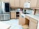 Bright kitchen features stainless steel refrigerator, lots of counter space and light wood cabinets at 4101 Limerick Dr, Lake Wales, FL 33859
