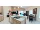 Open kitchen with stainless steel sink and breakfast bar leading into the living and dining areas at 4101 Limerick Dr, Lake Wales, FL 33859