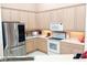 Well-equipped kitchen with stainless steel appliances and light wood cabinets at 4101 Limerick Dr, Lake Wales, FL 33859