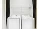 Practical laundry room featuring a white washer and dryer, and a shelf at 4101 Limerick Dr, Lake Wales, FL 33859