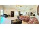 Open-concept living room featuring tile floors, vaulted ceilings, and abundant natural light at 4101 Limerick Dr, Lake Wales, FL 33859