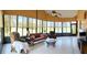 Bright sunroom featuring tile flooring and many large windows, offering views of the outdoors at 4101 Limerick Dr, Lake Wales, FL 33859