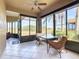 Bright sunroom with tile flooring, ceiling fan, large windows, and wicker furniture, perfect for relaxing and enjoying the view at 4101 Limerick Dr, Lake Wales, FL 33859