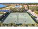 Aerial view of community tennis courts surrounded by trees and lush landscaping providing privacy at 4101 Limerick Dr, Lake Wales, FL 33859
