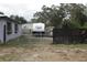View of the backyard with metal and wooden fencing that encompasses an RV, giving privacy at 5031 Timberlane Rd, Lake Wales, FL 33898