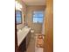Bathroom with vanity, toilet, window, and linen closet behind the door at 5031 Timberlane Rd, Lake Wales, FL 33898