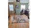 Cozy bedroom with floral rug, wood laminate floors, and vintage-style dresser at 5031 Timberlane Rd, Lake Wales, FL 33898