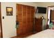 Bedroom with wood closet doors and dresser at 5031 Timberlane Rd, Lake Wales, FL 33898