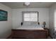 Simple bedroom with a wooden sleigh bed and window coverings at 5031 Timberlane Rd, Lake Wales, FL 33898