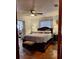 Warm and inviting bedroom with wood floors, ceiling fan, and furnishings at 5031 Timberlane Rd, Lake Wales, FL 33898