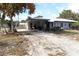 House with carport, covered patio, and gravel driveway at 5031 Timberlane Rd, Lake Wales, FL 33898