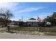 Ranch home with a metal roof and a fenced yard at 5031 Timberlane Rd, Lake Wales, FL 33898