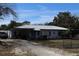 Charming single-story home with metal roof, carport and lots of room for parking at 5031 Timberlane Rd, Lake Wales, FL 33898