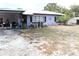 Exterior of the home with metal roof, carport and well-maintained yard at 5031 Timberlane Rd, Lake Wales, FL 33898
