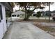 The front of the house features a well-manicured yard, plenty of room for parking and mature trees at 5031 Timberlane Rd, Lake Wales, FL 33898