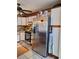 Bright kitchen featuring stainless steel refrigerator, gas range, tile floors, and ceiling fan at 5031 Timberlane Rd, Lake Wales, FL 33898