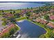 Scenic aerial view showcasing a lakeside community with meticulously maintained landscaping and picturesque water features at 802 Magnolia Pl, Winter Haven, FL 33884