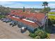 Aerial view of townhomes with red tile roofs, ample parking, and manicured landscaping at 802 Magnolia Pl, Winter Haven, FL 33884