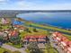 Stunning aerial view showcasing the community's prime lakeside location with beautiful landscaping and convenient parking at 802 Magnolia Pl, Winter Haven, FL 33884