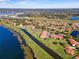 Wide aerial view of the community showcasing beautiful lakes, canals and meticulously maintained grounds at 802 Magnolia Pl, Winter Haven, FL 33884