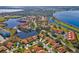Community aerial view highlighting lakes, green spaces, and residences with terra cotta roofs at 802 Magnolia Pl, Winter Haven, FL 33884