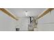 Unfinished basement with open ceiling, shelving, and water heater at 802 Magnolia Pl, Winter Haven, FL 33884