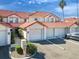 Charming townhouses featuring red tile roofs and private garages, landscaped for curb appeal at 802 Magnolia Pl, Winter Haven, FL 33884