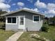 Charming home featuring a white door, grey exterior paint, and manicured lawn at 841 4Th St, Winter Haven, FL 33881