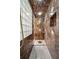 Large walk-in shower with marble walls and glass block accents at 104 Van Fleet Ct, Auburndale, FL 33823