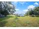 Large backyard with detached garage and mature trees at 118 7Th Terrace Wahneta Way, Winter Haven, FL 33880