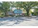 Brick and light blue two-story house with mature landscaping and a large tree at 1631 Monterey Ln, Lakeland, FL 33813