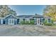 Charming single-story blue house with a well-maintained front yard and mature landscaping at 1769 S Lake Reedy Blvd, Frostproof, FL 33843