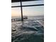 A serene view of a covered dock and calm waters from the comfort of a hot tub at 1769 S Lake Reedy Blvd, Frostproof, FL 33843