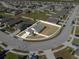 Aerial view of the home in a neighborhood with a fenced backyard and well-maintained landscaping at 1924 Amber Sweet Cir, Dundee, FL 33838